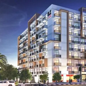 Modern multi-story residential building with balconies at dusk