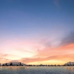 Panoramic view of waterfront residential buildings at sunset