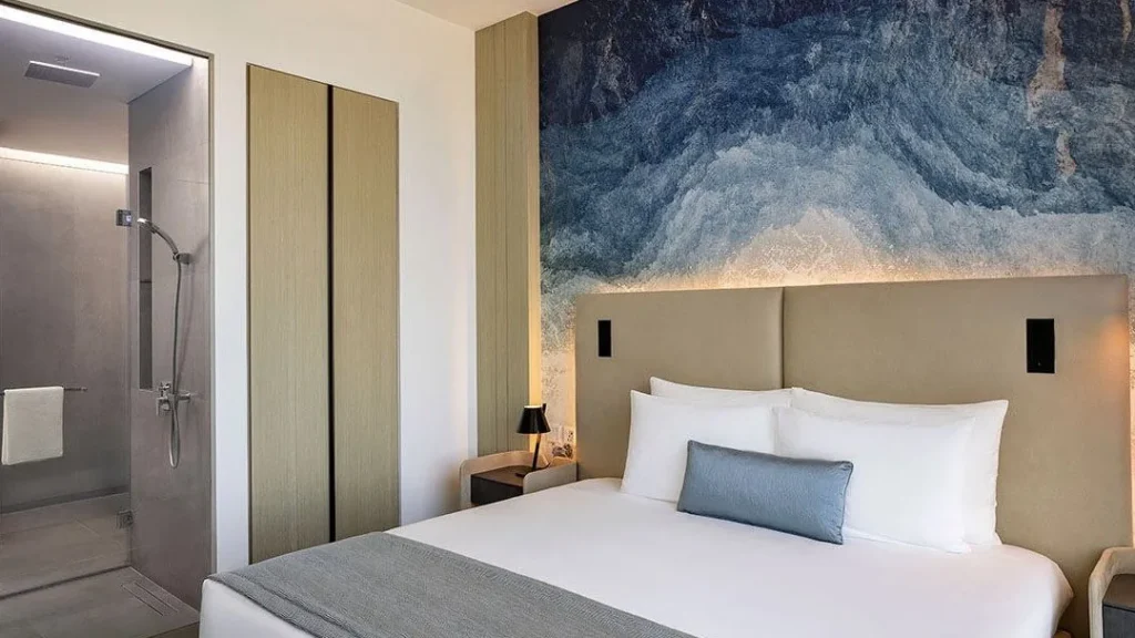 Studio bedroom with blue accent wall in Ciel Vignette Collection Dubai Marina Dubai