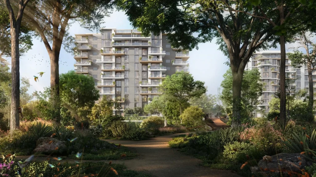Exterior view of residential buildings surrounded by trees at Ghaf Woods DubaiLand Dubai