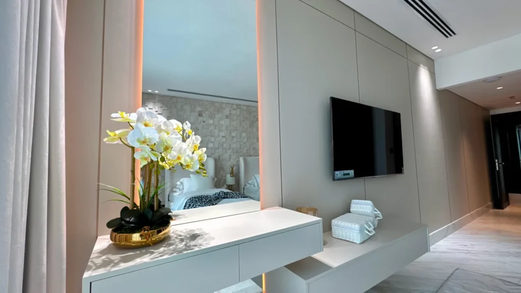 Living area with TV and decorative mirror Al Fattan Marine Towers Dubai Marina Dubai