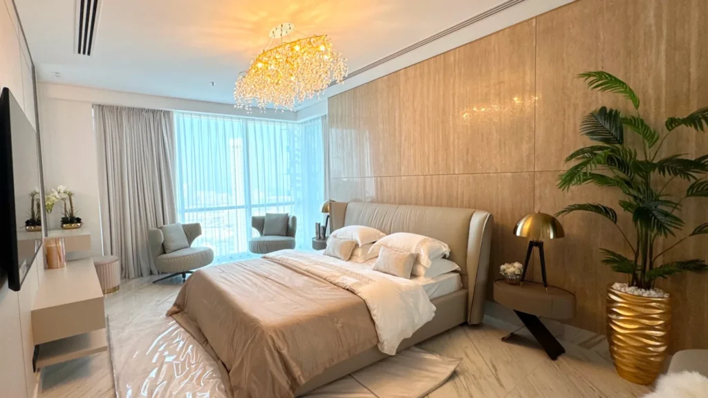 Bedroom with large bed and seating area in Al Fattan Marine Towers Dubai Marina Dubai