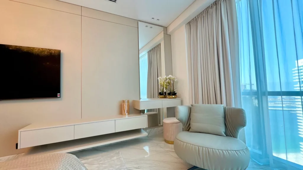 Living area with armchair and TV wall in Al Fattan Marine Towers Dubai Marina unit