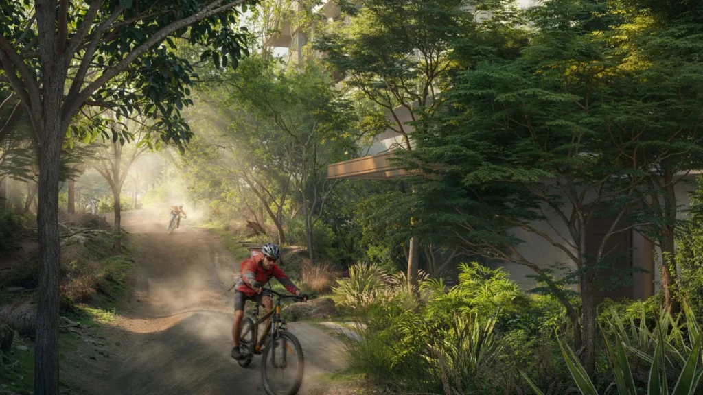 Cyclists riding on forest trail near apartment Ghaf Woods DubaiLand Dubai