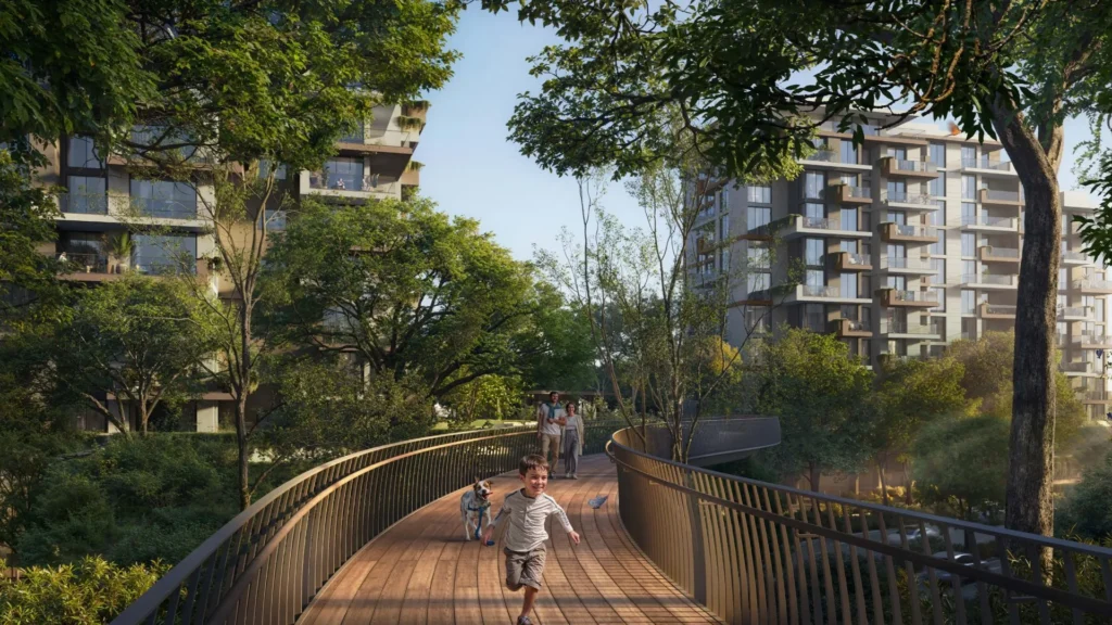 Outdoor pedestrian walkway with trees and residential buildings at Ghaf Woods DubaiLand Dubai