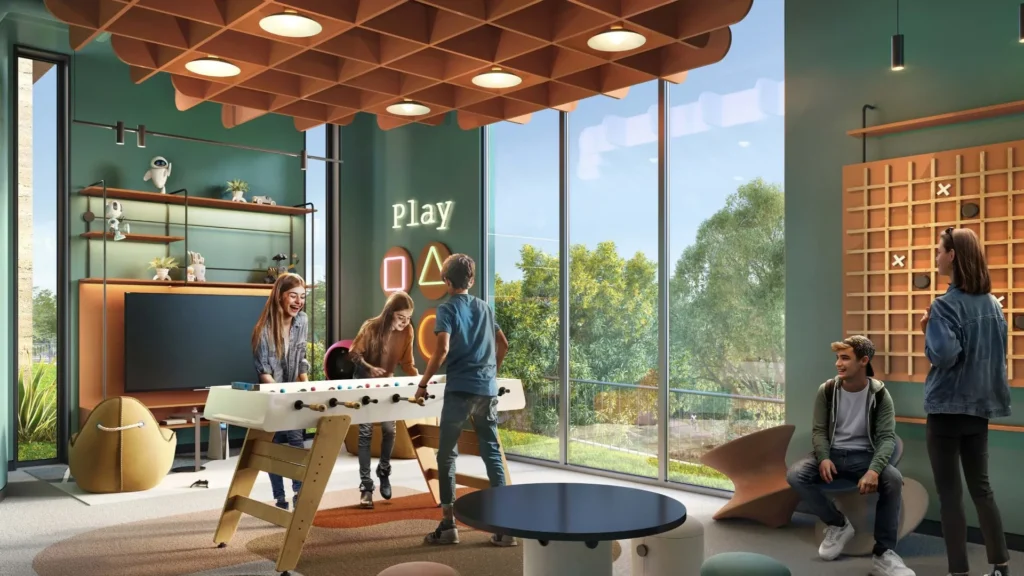 Games room with foosball table and seating at Ghaf Woods DubaiLand Dubai