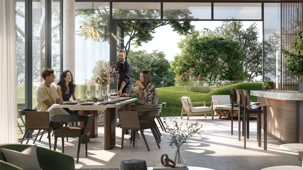 Dining area with large windows and garden view in Ghaf Woods DubaiLand apartment