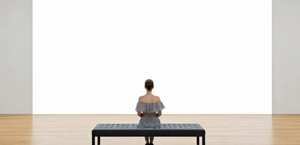 Woman sitting on bench in empty gallery space