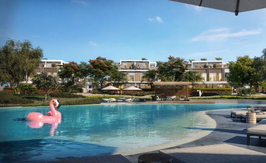 Pool with sun loungers and twin villas in background