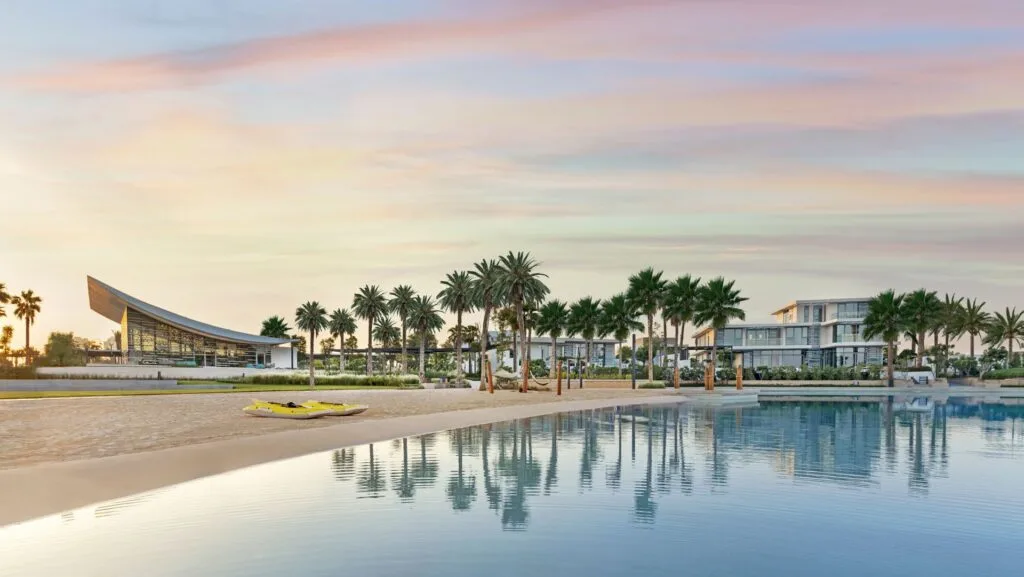 Exterior view of buildings and palm trees by a large pool