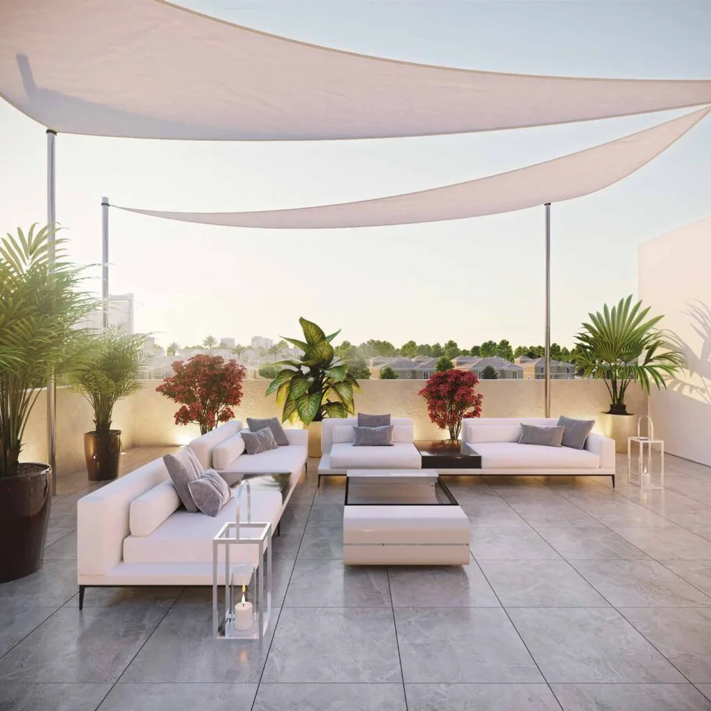 Outdoor seating area with white sofas and plants on terrace