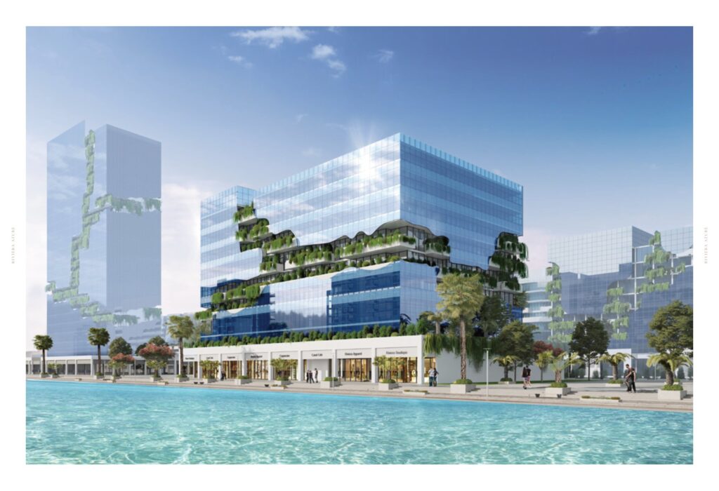 Modern glass buildings with greenery and waterfront promenade