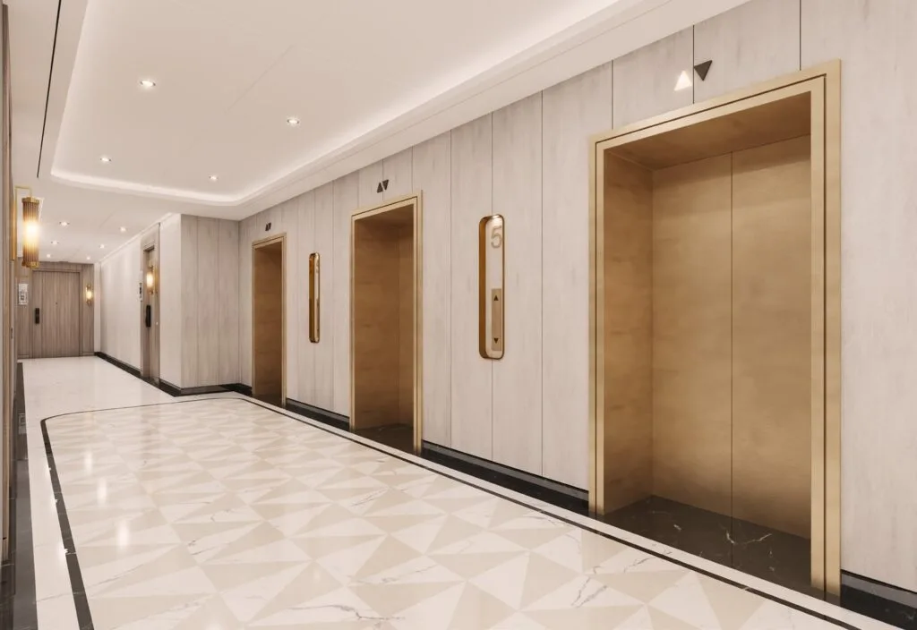 Interior corridor with three elevator doors and tiled floor