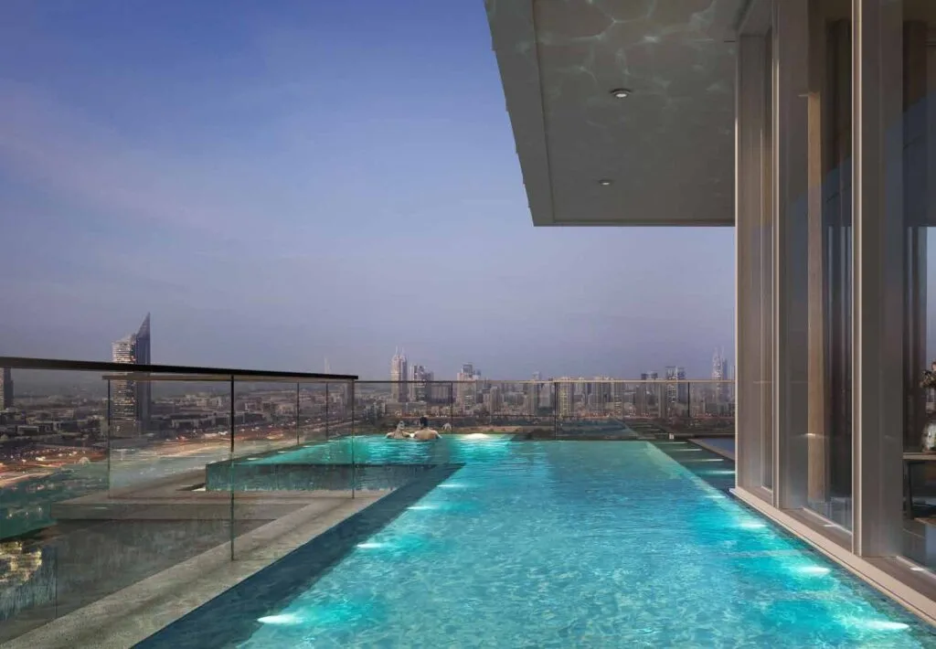 Rooftop infinity pool with city skyline view at dusk