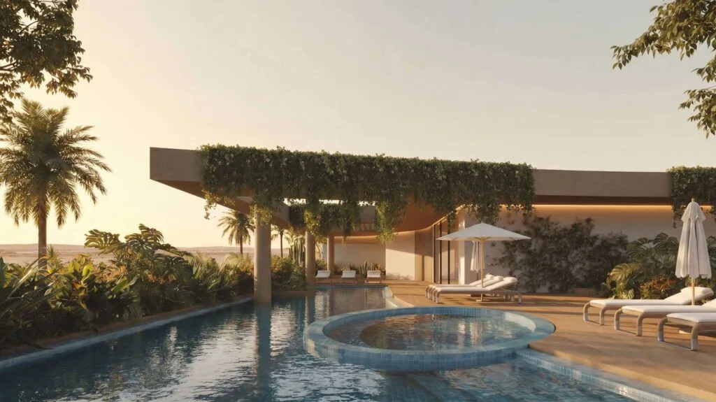 Outdoor pool area with lounge chairs and shaded terrace