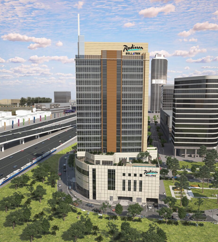 Tall building with glass windows near road and train tracks