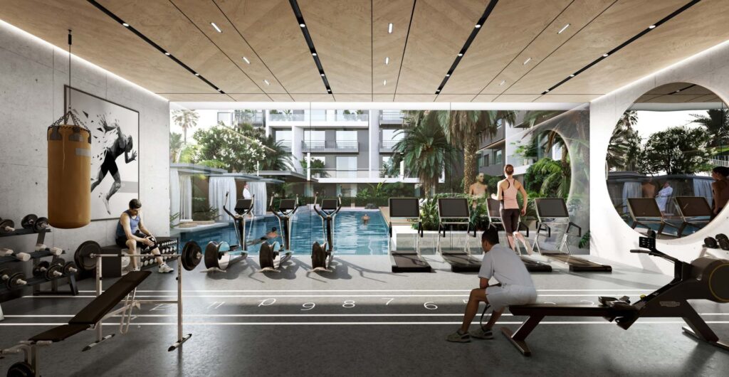 Indoor gym with weights and outdoor pool visible through glass