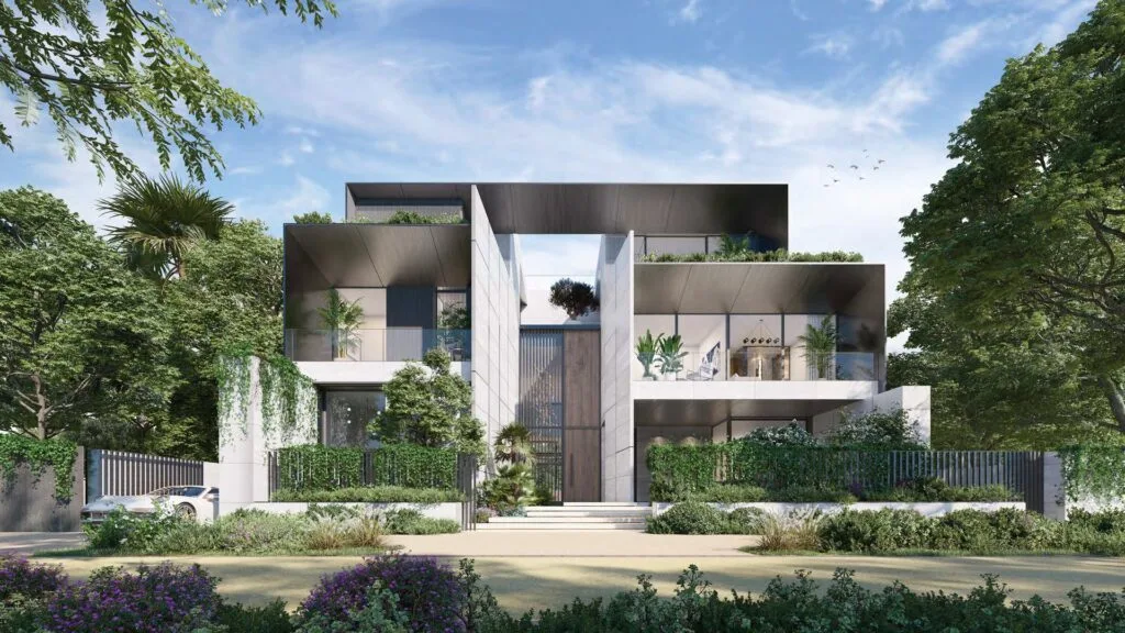 Modern multi-level residential building with greenery and clear sky