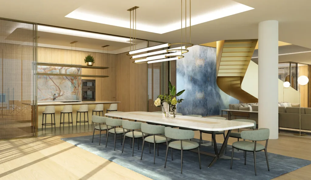 Mansion dining and kitchen area with long marble table, pendant lights and feature staircase (developer rendering)