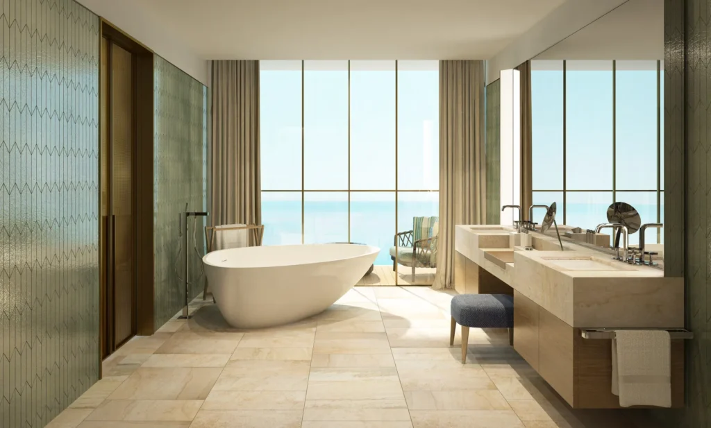 Master bathroom with freestanding bath, stone vanity and full-height windows to the sea (developer rendering)