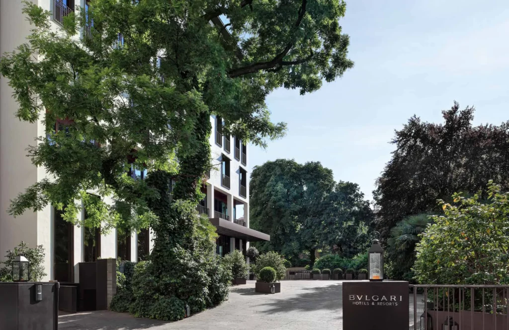Residence entrance among mature trees with Bulgari signage at Bulgari Resort and Residences