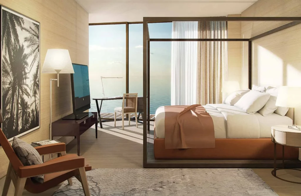 Residence bedroom with canopy bed and floor-to-ceiling window overlooking the sea (developer rendering)