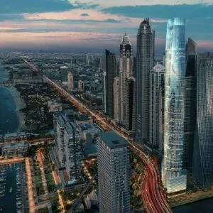 Tall illuminated skyscraper in Dubai Marina at night