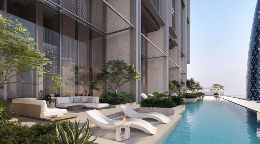Outdoor pool area with lounge chairs and modern building facade