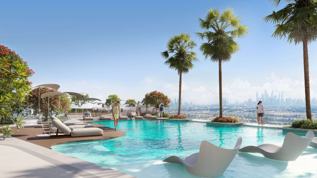 Pool deck with sun loungers and palm trees overlooking city skyline