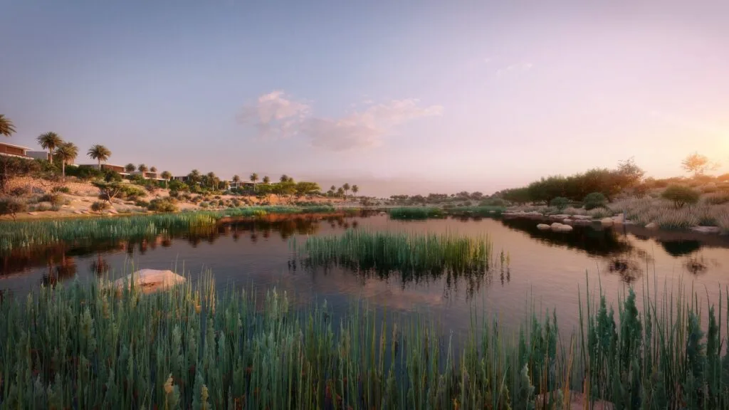 Water body with desert landscape and vegetation at sunset