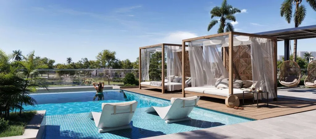 Outdoor pool area with lounge chairs and cabanas
