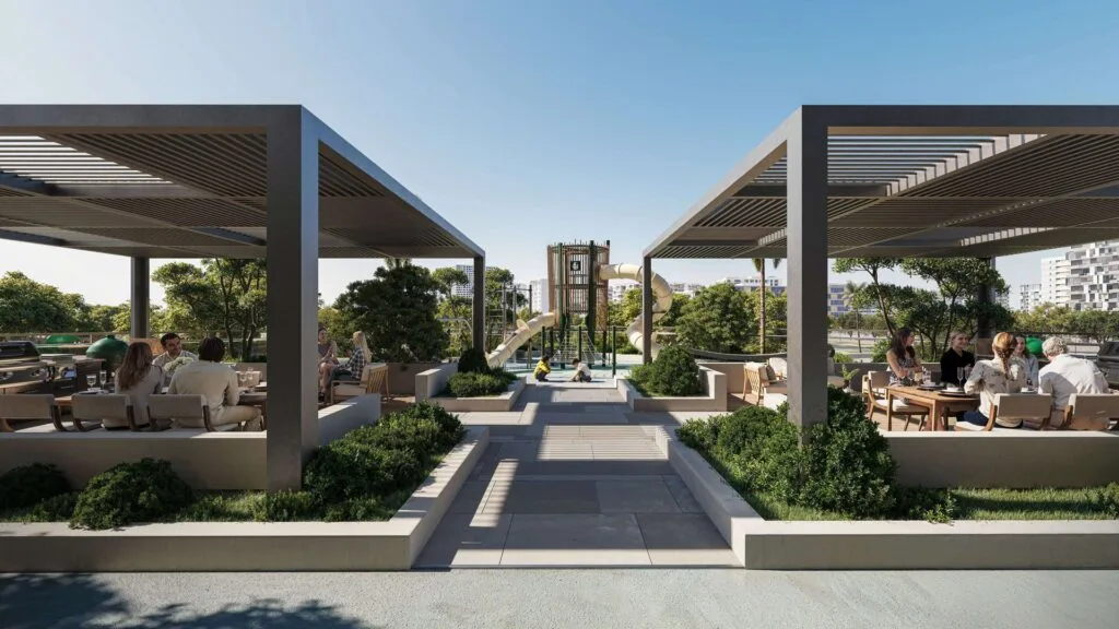 Outdoor seating area with pergolas and playground in background