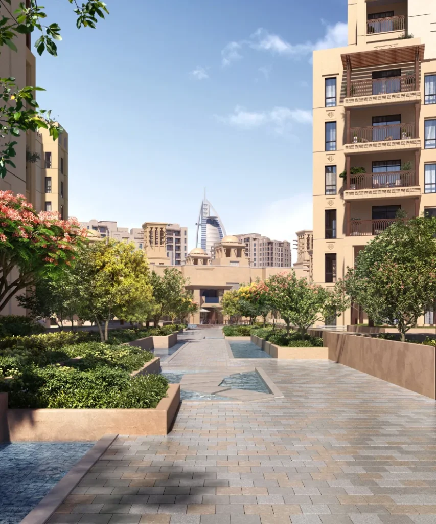 Jadeel by Meraas in Madinat Jumeirah Living, Dubai — Landscaped residential walkway with Dubai skyline backdrop