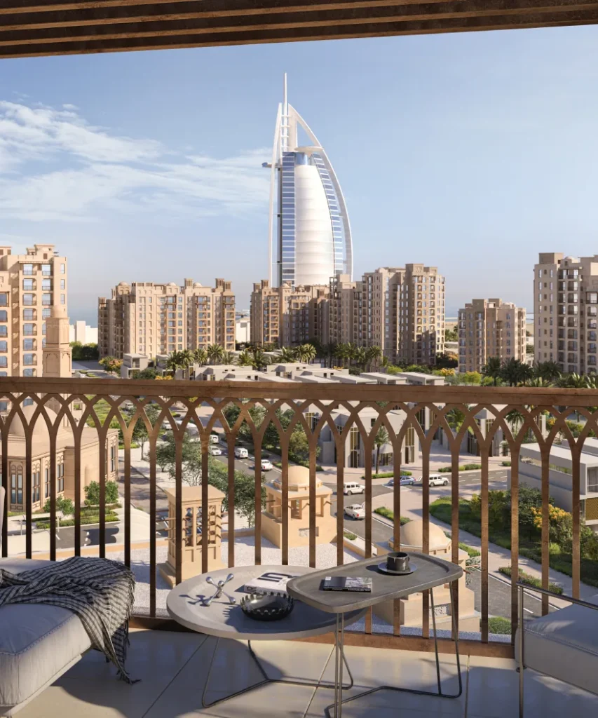 Jadeel by Meraas in Madinat Jumeirah Living, Dubai — Furnished balcony overlooking residential buildings and landmark hotel