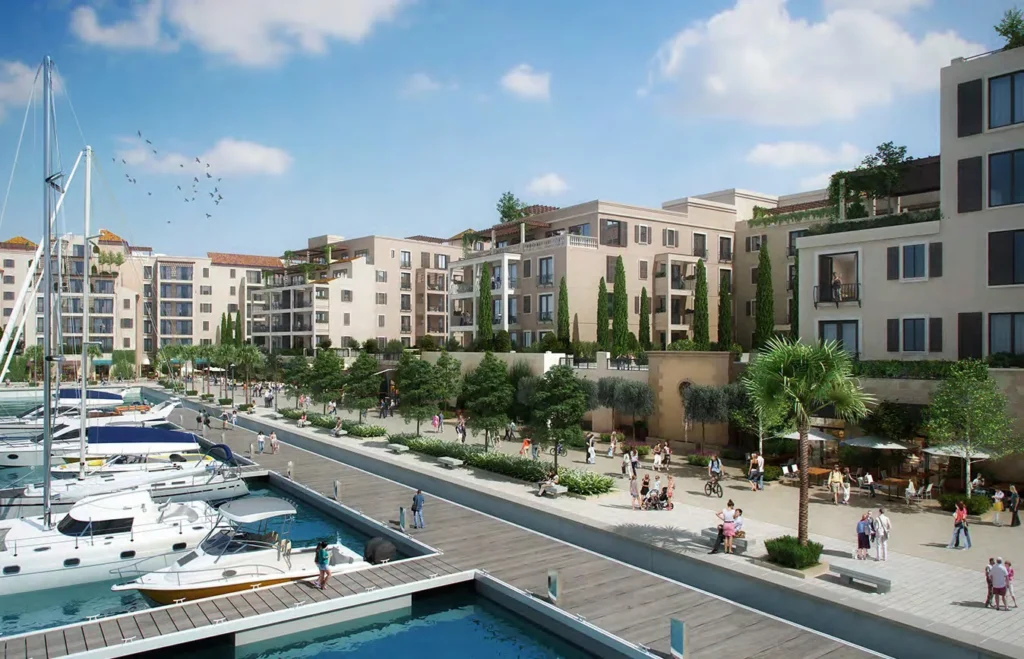Marina promenade with yachts beside apartment buildings with terraces at Port de La Mer (developer rendering)