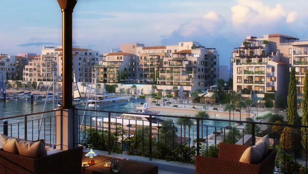 Balcony view over the marina toward waterfront apartment buildings at Port de La Mer (developer rendering)