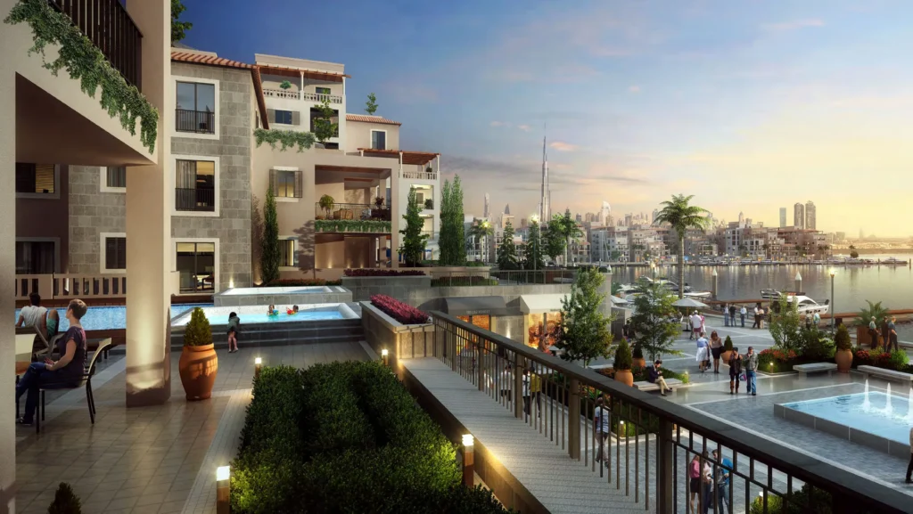 Terrace overlooking the marina promenade and apartment buildings at dusk, Port de La Mer (developer rendering)