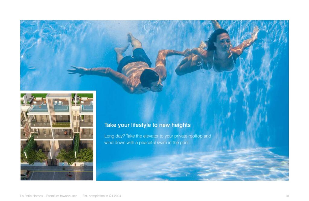 Two people swimming underwater in a pool with building inset
