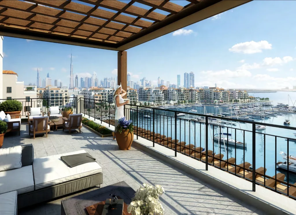 Terrace with lounge seating and pergola overlooking the marina and Dubai skyline from La Rive (developer rendering)