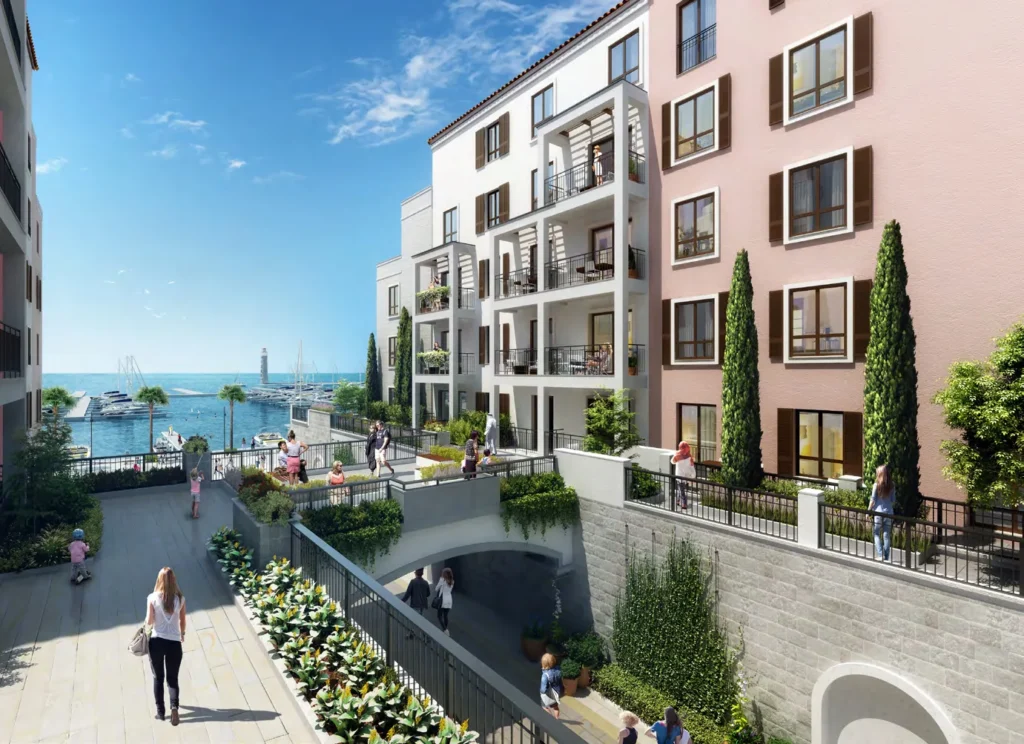 Pedestrian bridge and balconies of a pink-toned La Rive apartment building with sea view (developer rendering)