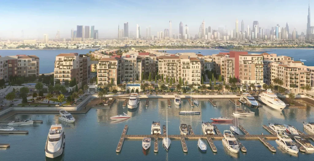 Panoramic view of the La Sirene marina with yachts and apartment buildings, Dubai skyline behind (developer rendering)