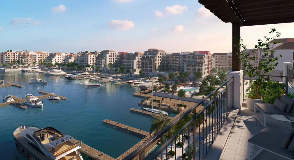 Balcony view over the marina and waterfront buildings at Port de La Mer (developer rendering)