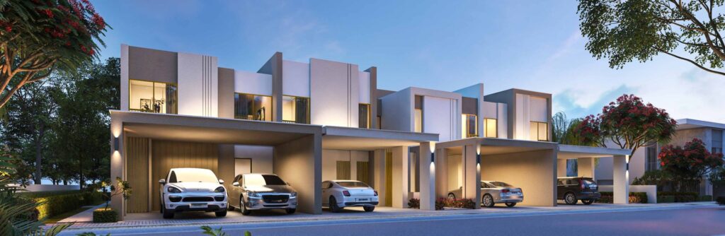Exterior view of modern townhouses with parked cars at dusk