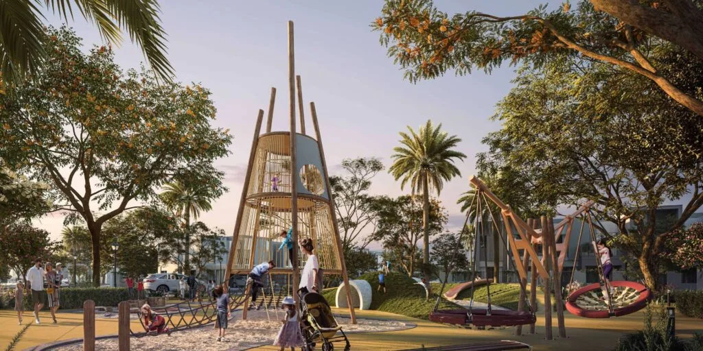 Outdoor playground with climbing structure and swings surrounded by trees