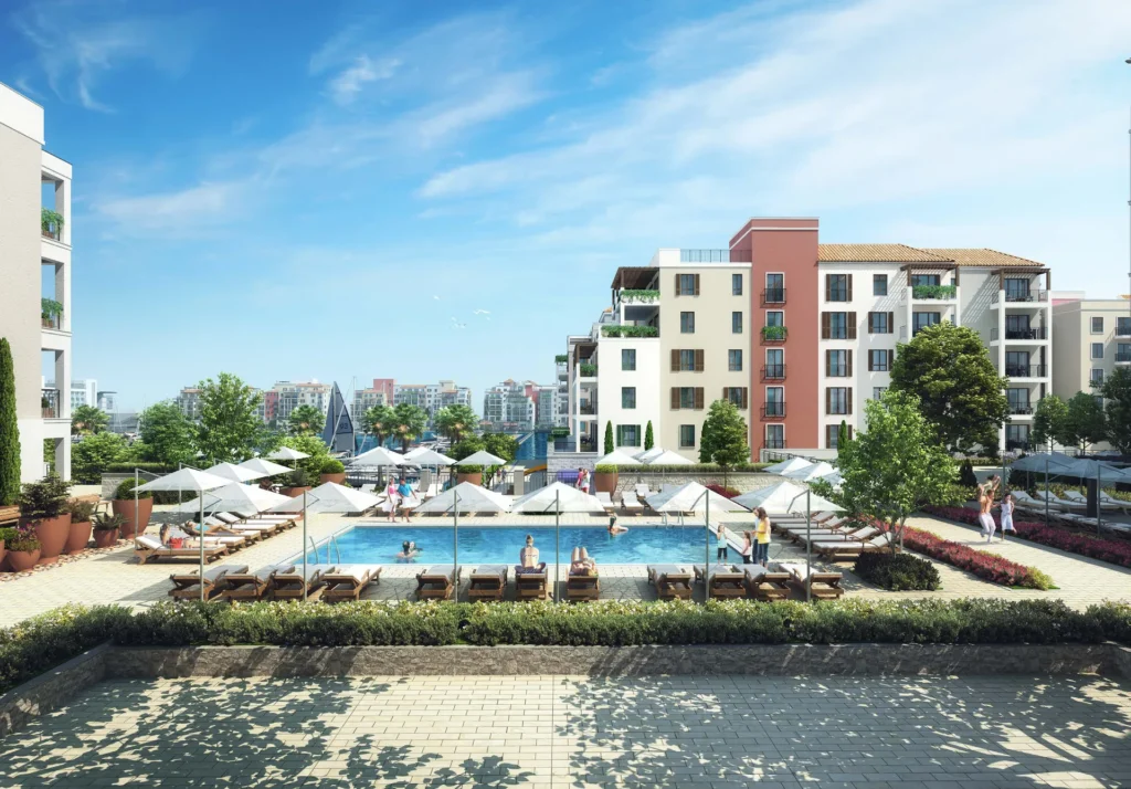 Pool terrace with sun loungers in front of La Voile apartment buildings (developer rendering)