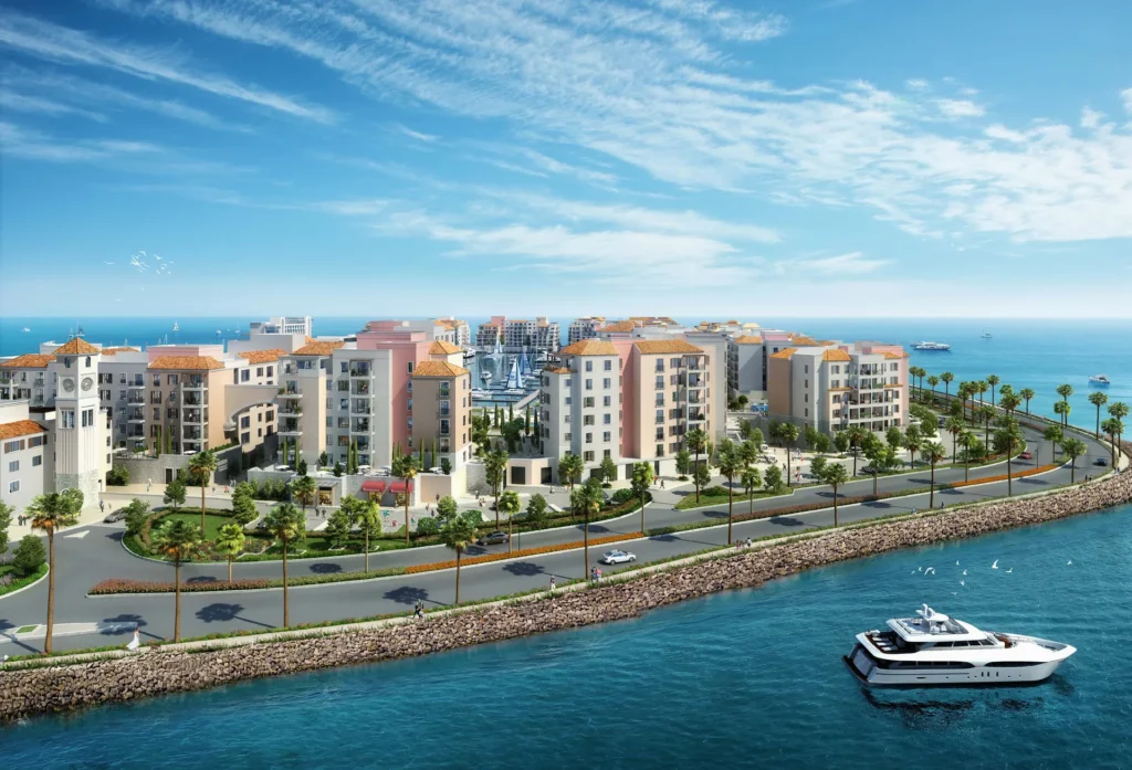 Aerial view of La Voile apartment buildings along the waterfront road and the sea (developer rendering)