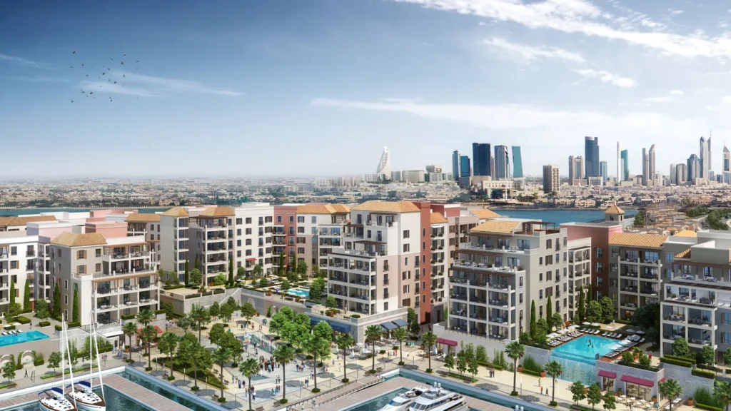Aerial view of La Voile residential buildings with rooftop pools and the Dubai skyline at Port de La Mer (developer rendering)