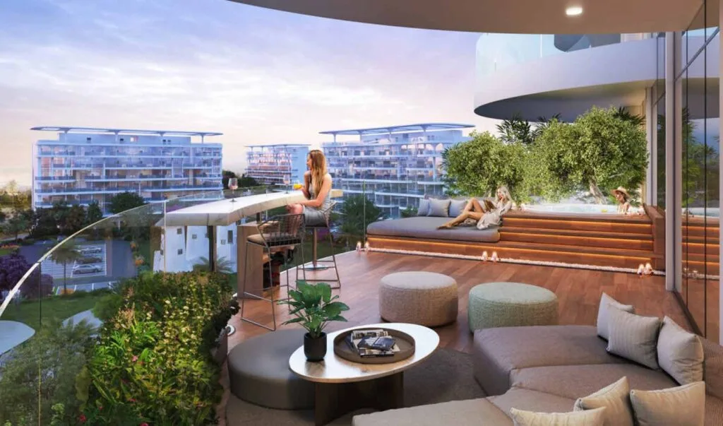 Balcony seating area with plants and distant buildings