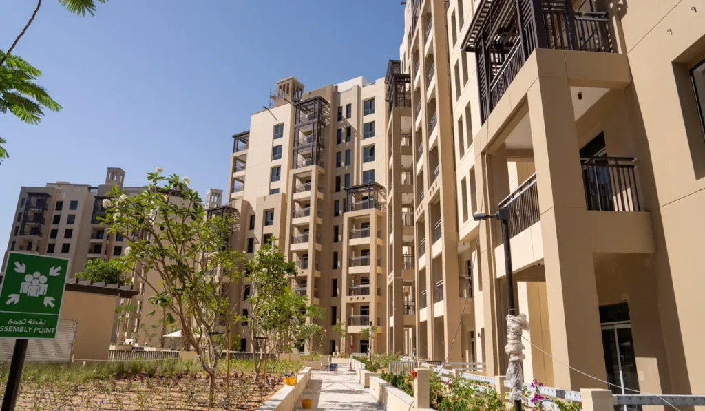 Lamaa Mjl by Meraas in Madinat Jumeirah Living, Dubai — Sunlit residential buildings surrounding landscaped pedestrian courtyard