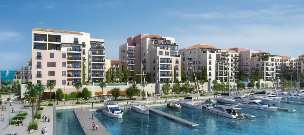 Le Pont waterfront apartment buildings along the marina with moored boats (developer rendering)